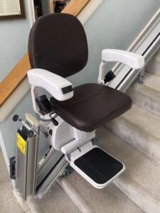 The Pilot Aviator E603 Straight Stairlift with Dark Brown Seat and Optional Folding Hinged Rail